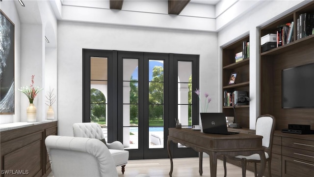 office area featuring built in shelves, a healthy amount of sunlight, and light wood-type flooring