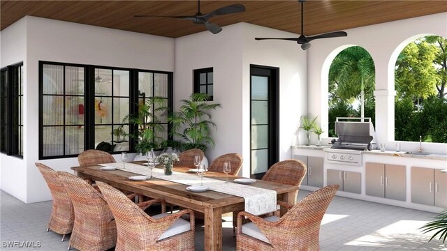 view of patio with exterior kitchen, area for grilling, and ceiling fan