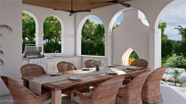 view of patio / terrace with ceiling fan, an outdoor kitchen, and sink