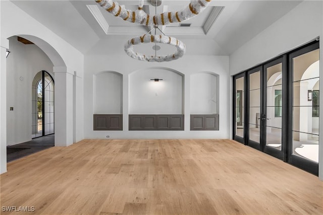 unfurnished room featuring a tray ceiling and french doors