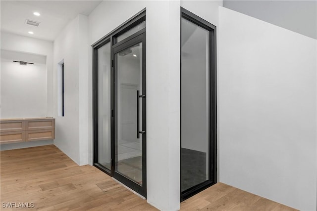 corridor featuring light hardwood / wood-style flooring