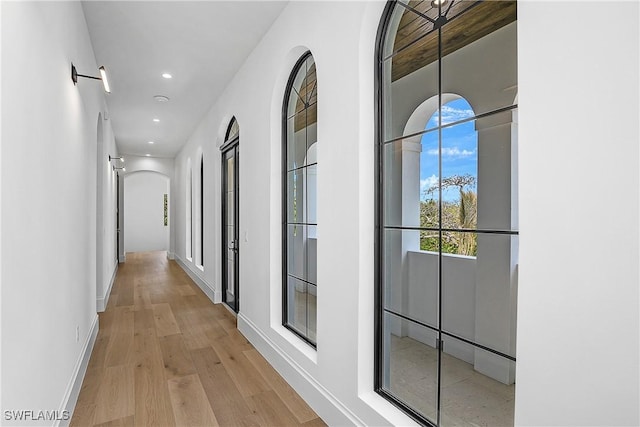 50 Mahogany Dr, Naples, FL 34108 - hall with recessed lighting, arched walkways, wood finished floors, and baseboards