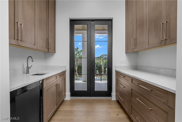50 Mahogany Dr, Naples, FL 34108 - kitchen featuring light wood finished floors, a sink, dishwashing machine, light countertops, and french doors