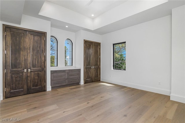 50 Mahogany Dr, Naples, FL 34108 - entryway with baseboards, light wood-type flooring, a raised ceiling, and recessed lighting