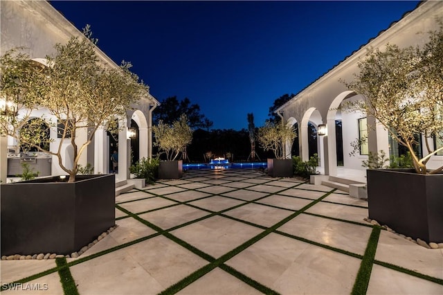 50 Mahogany Dr, Naples, FL 34108 - patio at night with an outdoor pool