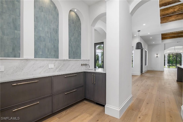 50 Mahogany Dr, Naples, FL 34108 - bar with recessed lighting, baseboards, decorative backsplash, and light wood-type flooring