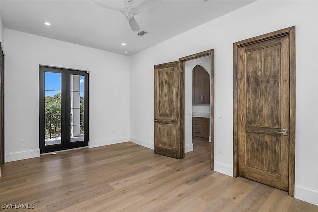 50 Mahogany Dr, Naples, FL 34108 - spare room featuring arched walkways, light wood-style flooring, ceiling fan, baseboards, and french doors