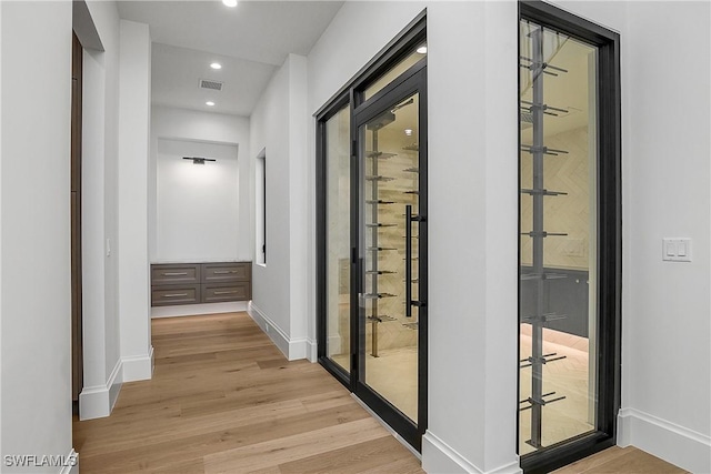 50 Mahogany Dr, Naples, FL 34108 - wine room with light wood-style floors, recessed lighting, visible vents, and baseboards