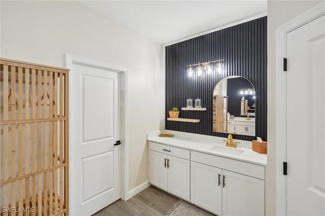 bathroom featuring wood finished floors, vanity, and baseboards