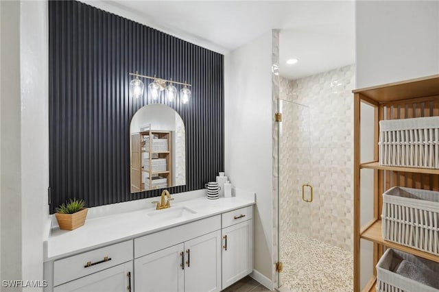 bathroom featuring a shower stall, vanity, and baseboards