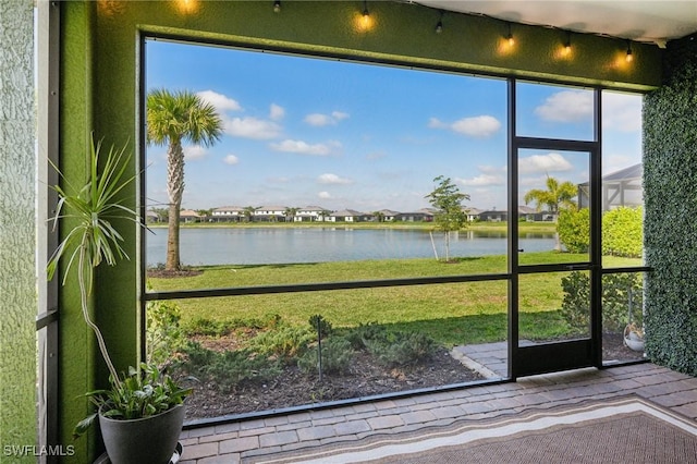 unfurnished sunroom featuring a water view