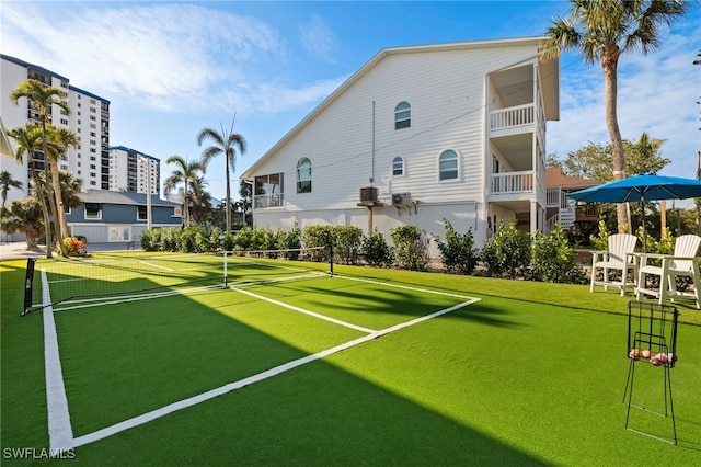 view of home's community with tennis court