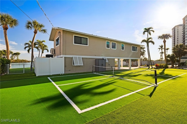 view of tennis court featuring fence
