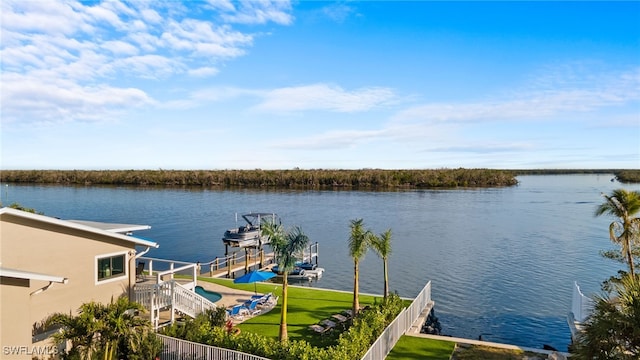 view of dock featuring a water view and a yard