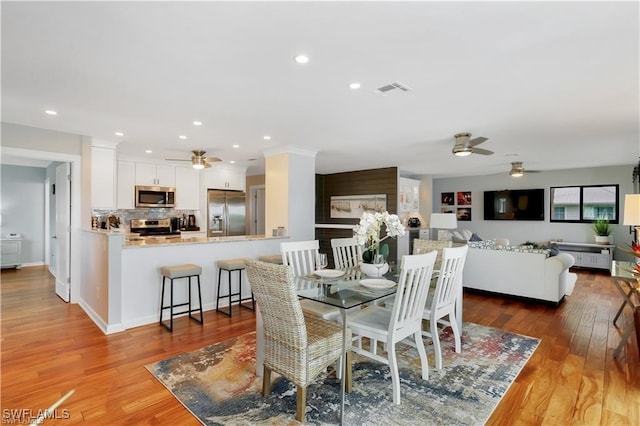 dining area featuring hardwood / wood-style floors and ceiling fan