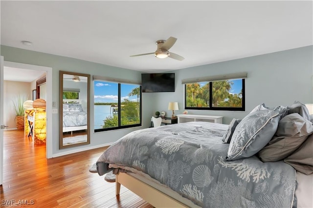 bedroom with ceiling fan and light hardwood / wood-style floors