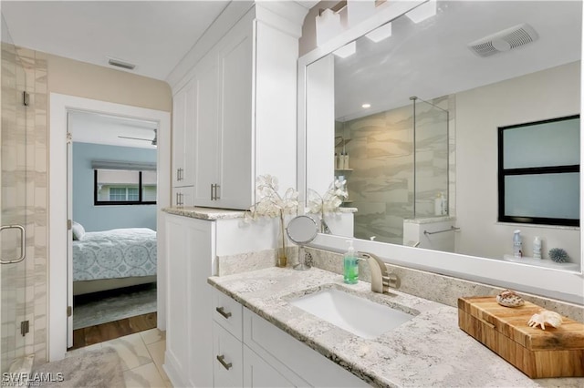 bathroom featuring vanity and an enclosed shower