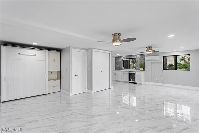 unfurnished living room featuring a wall mounted air conditioner, beverage cooler, and ceiling fan