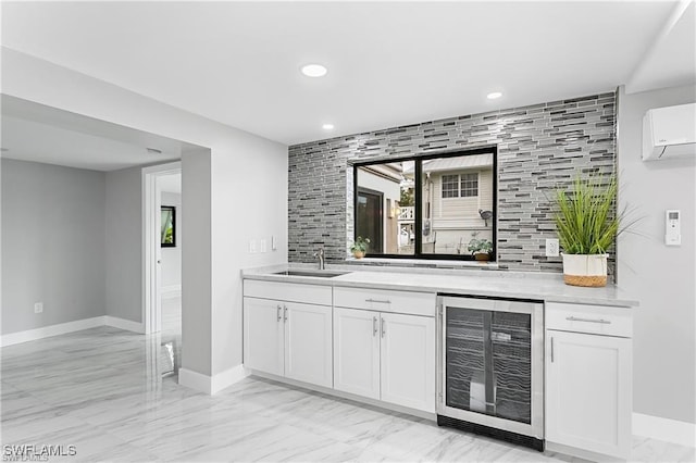 bar featuring sink, a wall mounted air conditioner, beverage cooler, and white cabinets