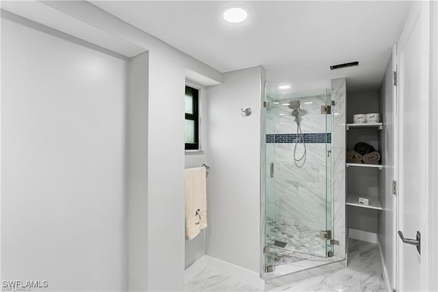 bathroom with a shower with door