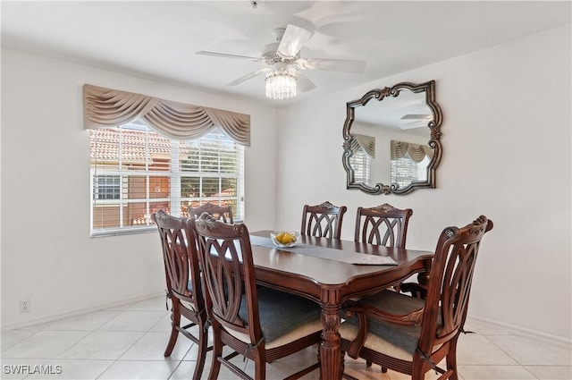 tiled dining space featuring ceiling fan