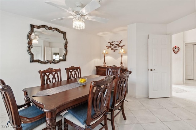 tiled dining space with ceiling fan