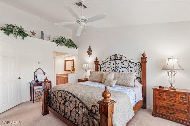 carpeted bedroom with lofted ceiling and ensuite bath