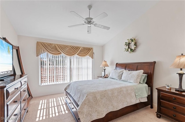 carpeted bedroom featuring vaulted ceiling and ceiling fan