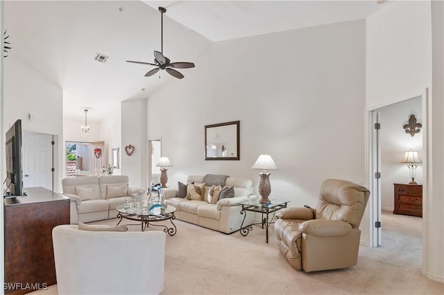 carpeted living room featuring ceiling fan and high vaulted ceiling