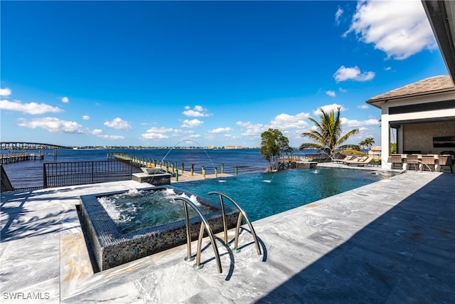 view of swimming pool featuring a water view, an outdoor bar, pool water feature, a patio, and a jacuzzi