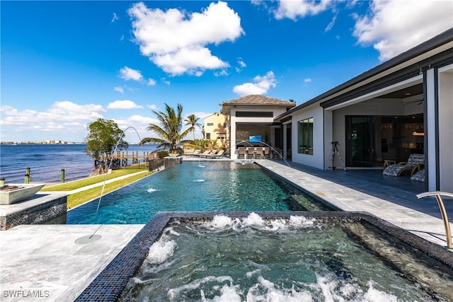 view of swimming pool featuring a patio, pool water feature, an in ground hot tub, and a water view