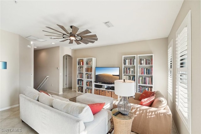 tiled living room with ceiling fan