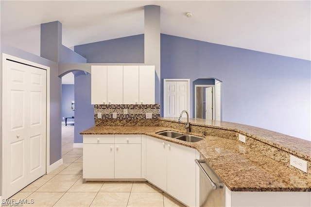 kitchen featuring white cabinetry, stainless steel dishwasher, sink, and stone counters