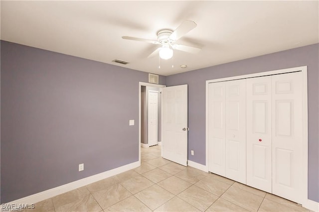 unfurnished bedroom featuring light tile patterned floors, ceiling fan, and a closet