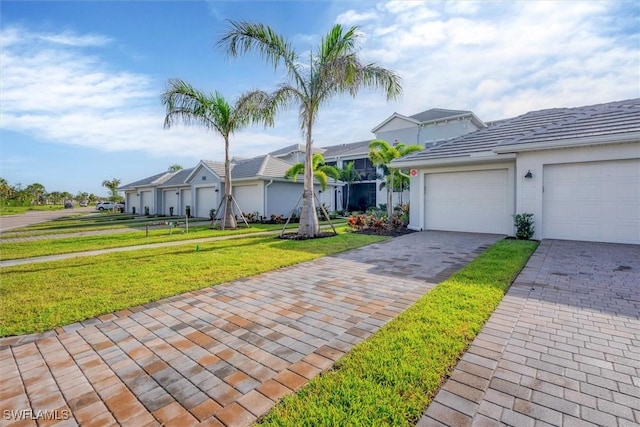 view of front of house with a garage and a front yard