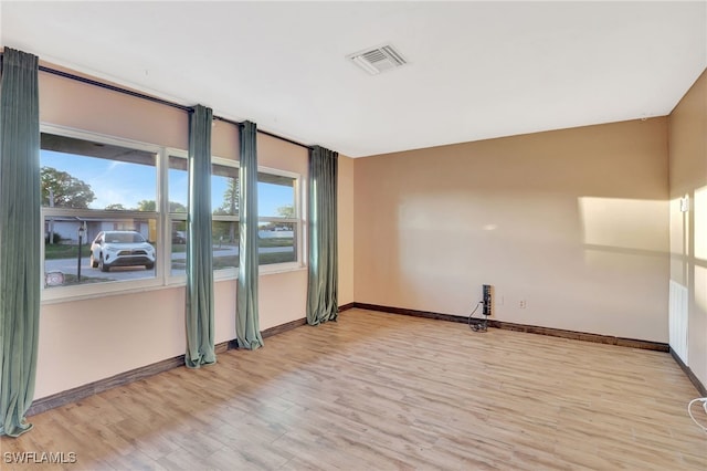 unfurnished room featuring light hardwood / wood-style flooring