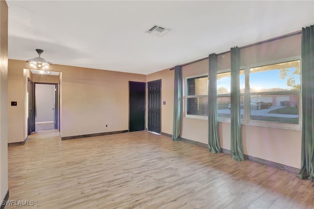 unfurnished room with light hardwood / wood-style flooring