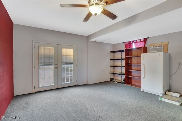 unfurnished room with french doors, light colored carpet, a wall mounted AC, and ceiling fan