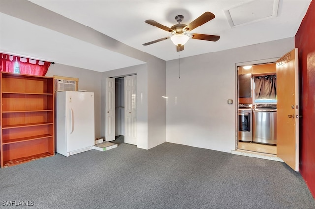 interior space with dark colored carpet, white fridge, independent washer and dryer, and a closet