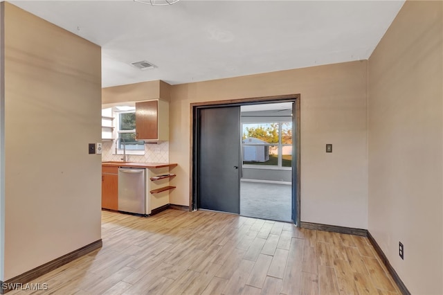 interior space featuring sink, a healthy amount of sunlight, and light wood-type flooring