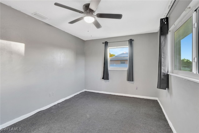 carpeted spare room featuring ceiling fan