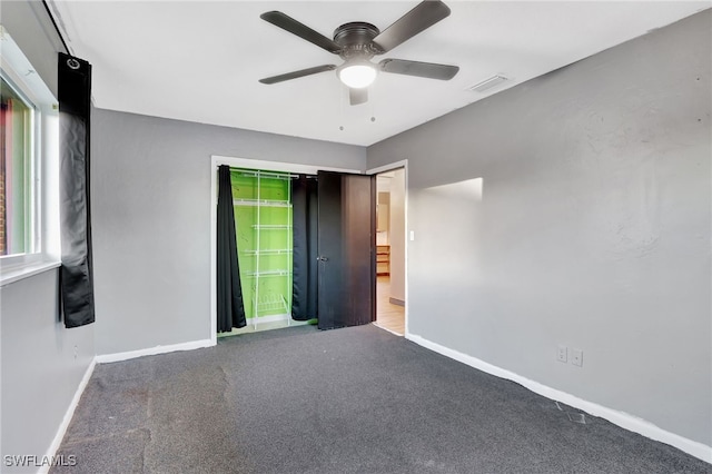 empty room featuring carpet floors and ceiling fan