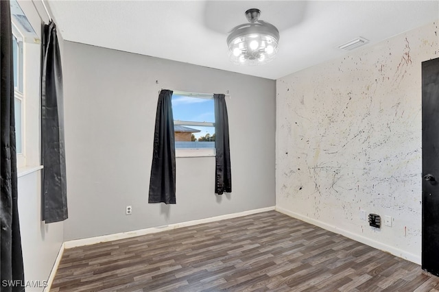 spare room featuring dark wood-type flooring