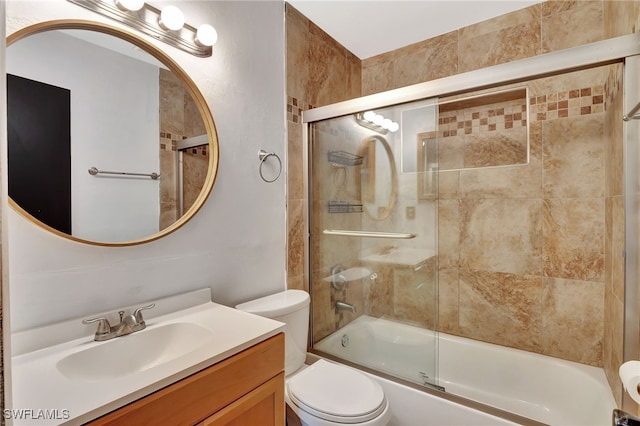 full bathroom with vanity, bath / shower combo with glass door, and toilet