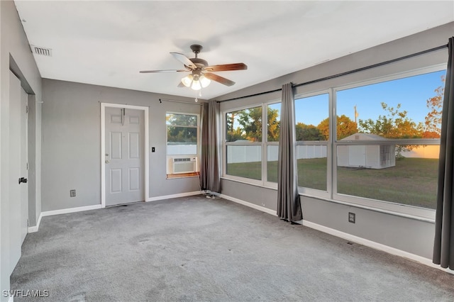 unfurnished room with carpet, cooling unit, and ceiling fan