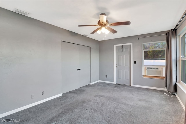 empty room with cooling unit, ceiling fan, and carpet