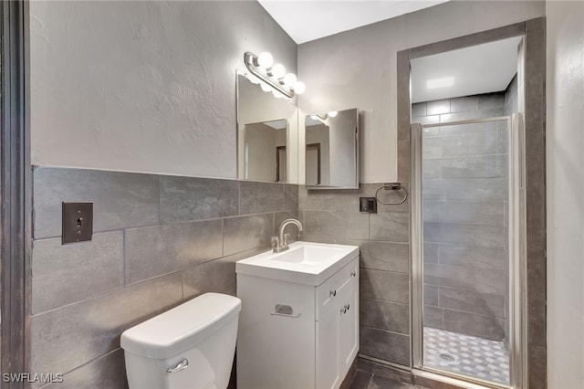 bathroom featuring vanity, tile walls, an enclosed shower, and toilet