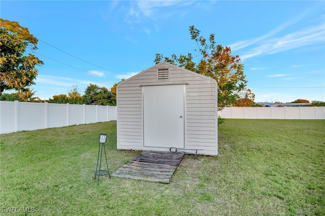 view of outbuilding with a yard