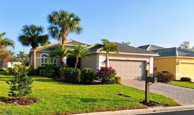 view of front of home with a garage and a front lawn