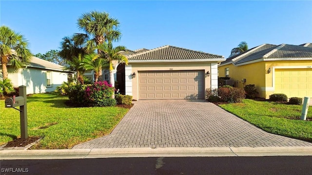 view of front of home with a garage and a front lawn